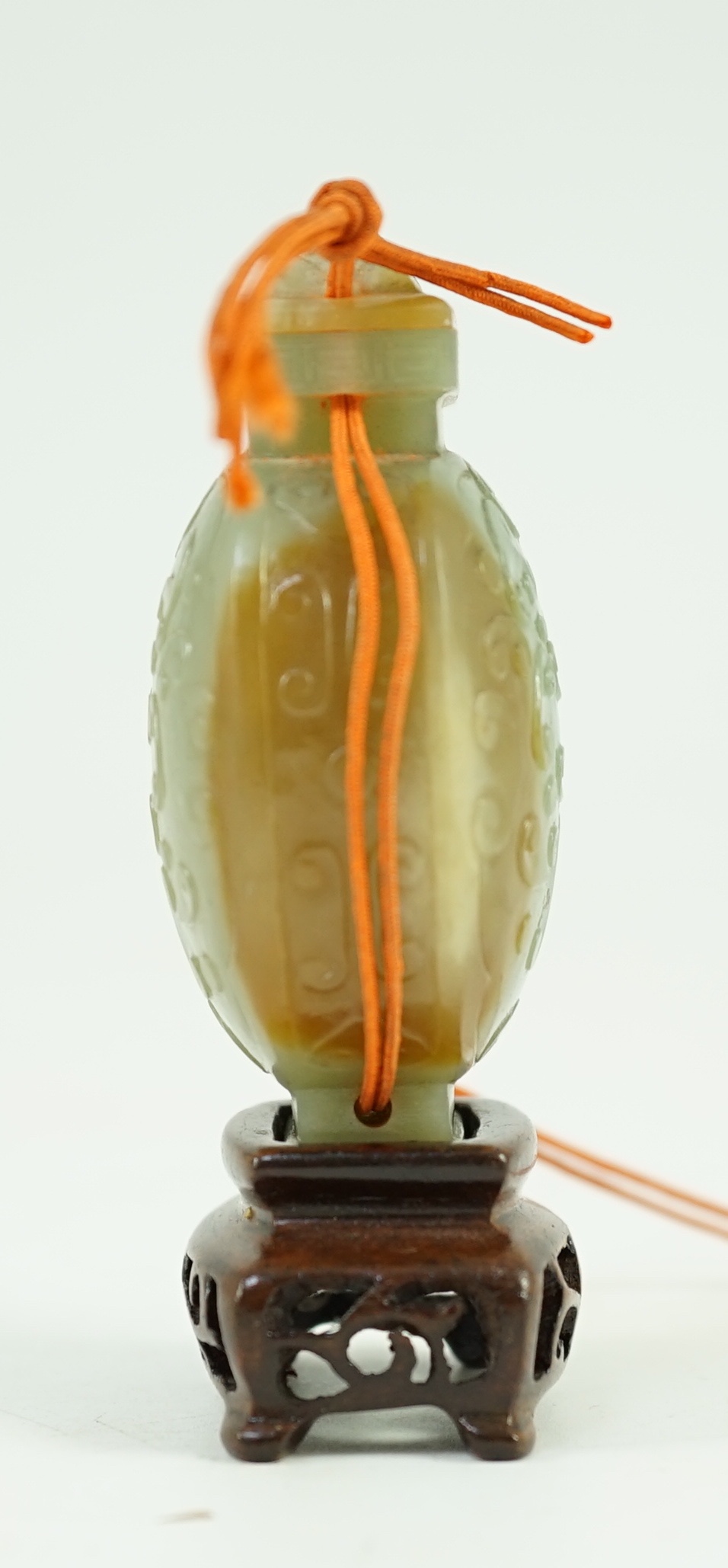 A Chinese archaistic green and russet jade miniature vase and cover, fanghu, 19th century, 6.7 cm high, foot re-carved, wood stand